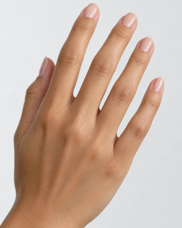 A hand wearing a ring at the position this stone would sit, for sizing and skin-tone reference only